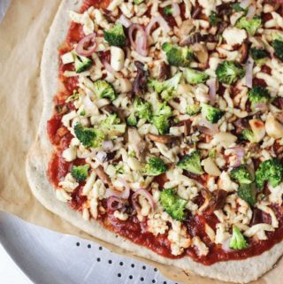 Vegan and gluten-free pizza crust make with flaxseed, almond flour with toppings.