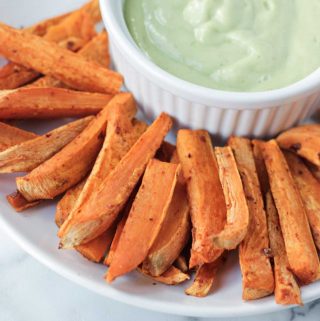 Oil-free sweet potato fries on a platter with dipping sauce.