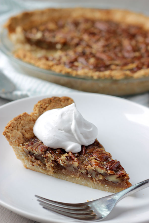 Pecan pie slice on white plat