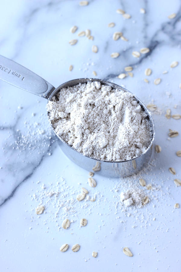 Oat flour in a measuring cup