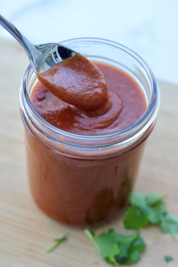 OIl-free, vegan Enchilada Sauce on a spoon.