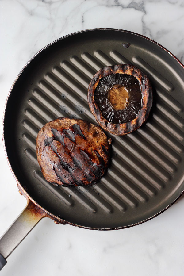 Balsamic grilled portobello mushrooms on a grilling pan.