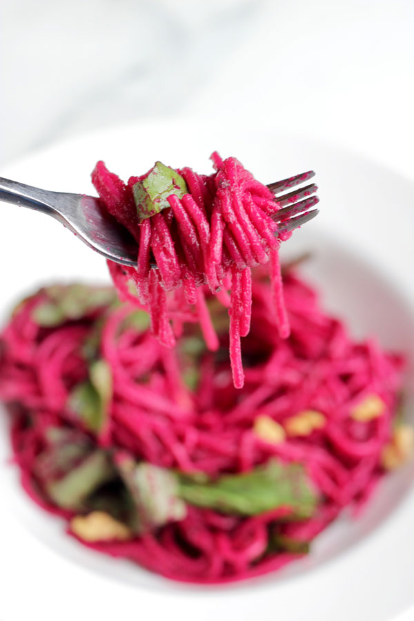 Pink beet pasta on a fork