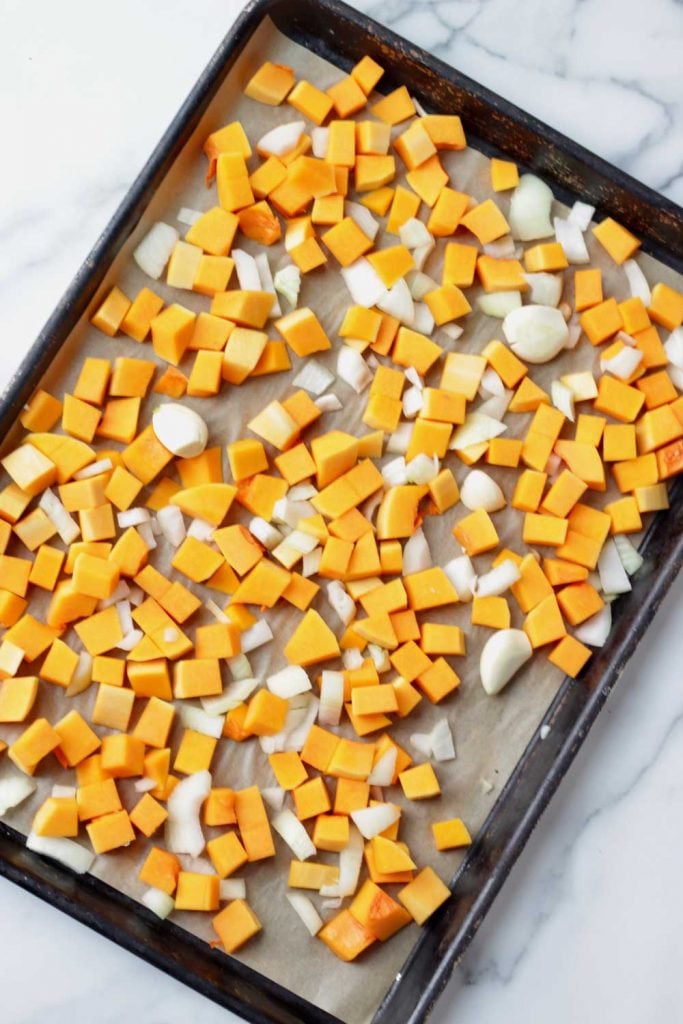 butternut squash, onion and garlic on a sheet pan