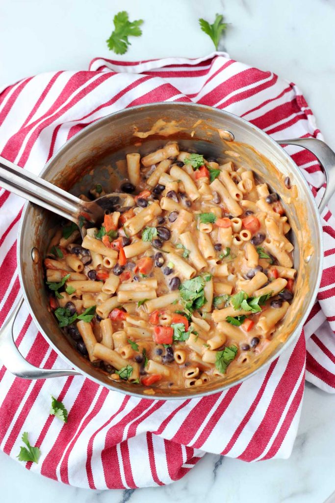 Vegan taco pasta in pan on red and white towl