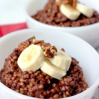 Chocolate buckwheat porridge in white bowls with bananas and pecans