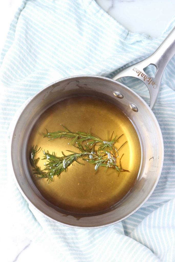 Rosemary simple syrup in a saucepan