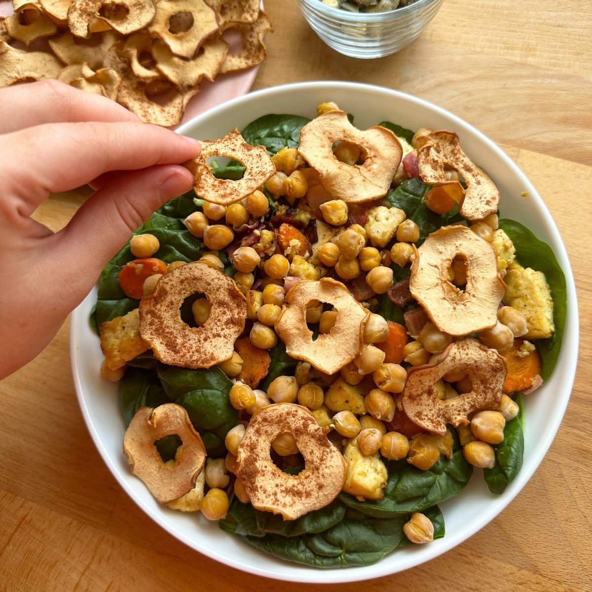 Placed baked cinnamon apple chips on harvest salad.