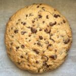 Air fryer cookie with chocolate chips on parchment paper.
