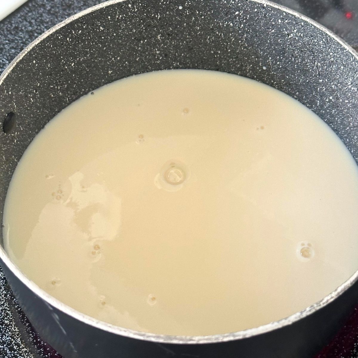 Milk heating up on stove.
