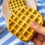 Crispy golden tofu waffle with a blue and white striped cloth background.