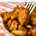 Baked BBQ tofu nuggets in a bowl with a fork in one.