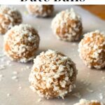 Coconut date balls on a sheet of parchment paper with a few pieces of shredded coconut, text reads "coconut date balls".
