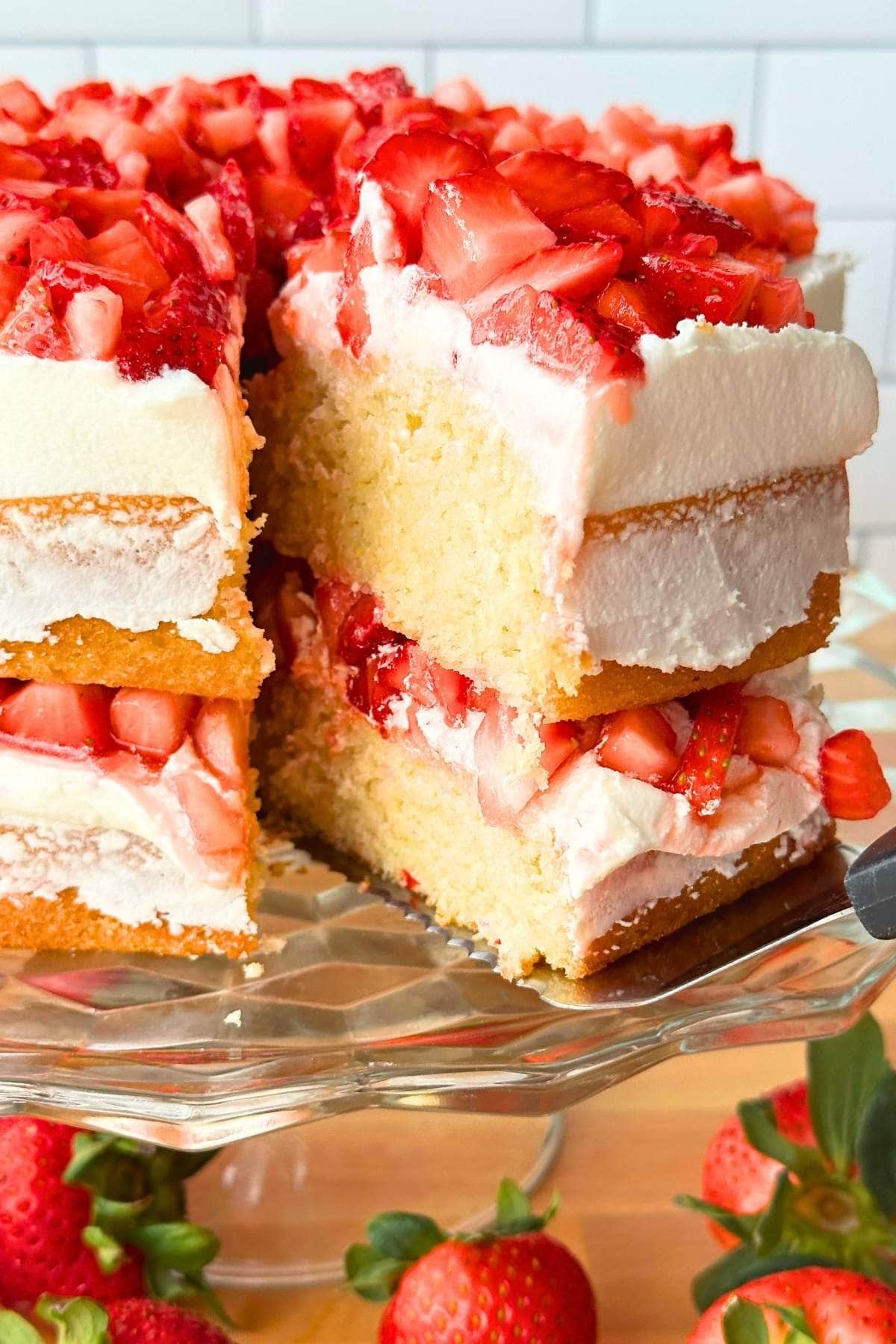 Slice of strawberry lemon cake being pulled out of the cake.