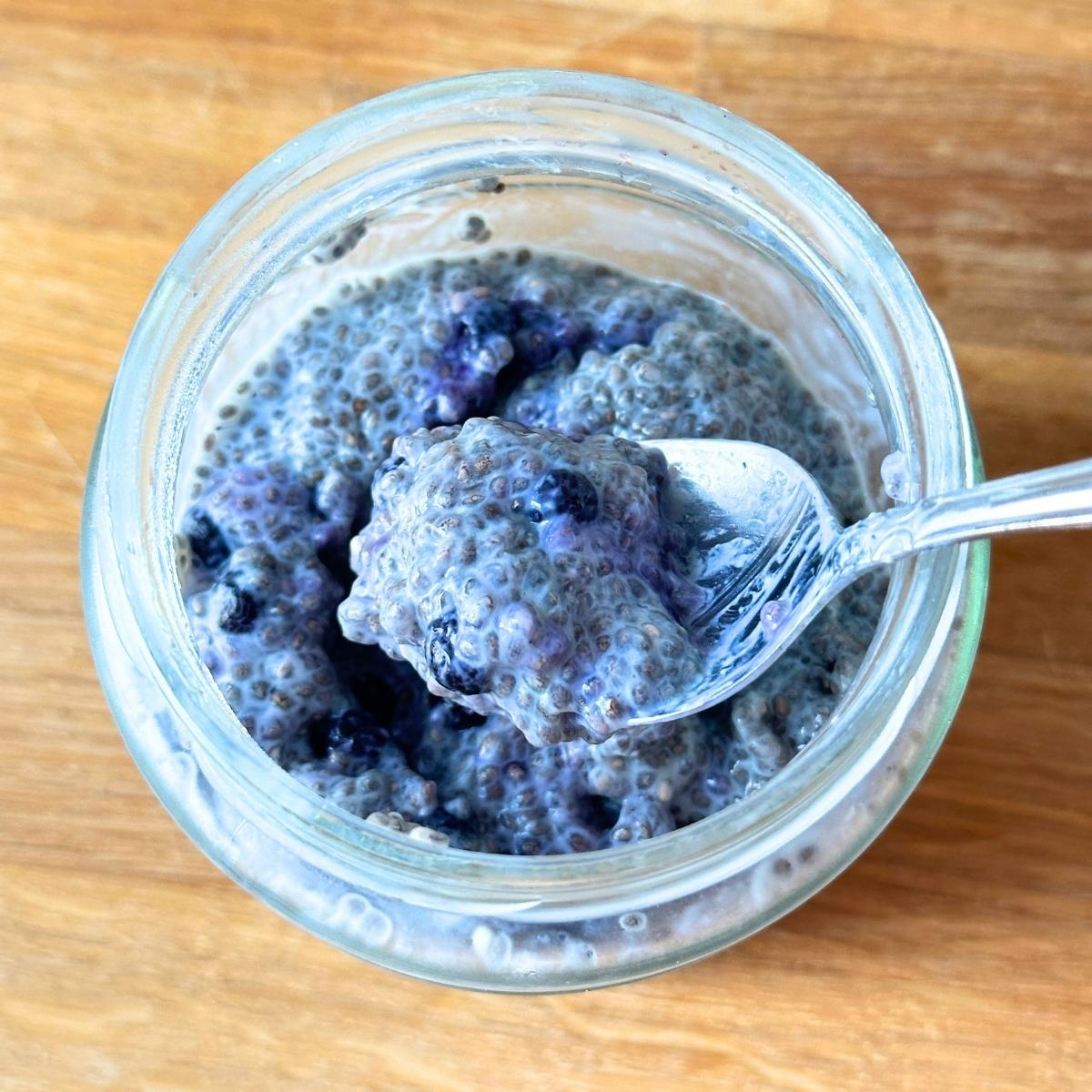 Chia pudding with blueberries completely gelled together after chilling overnight.