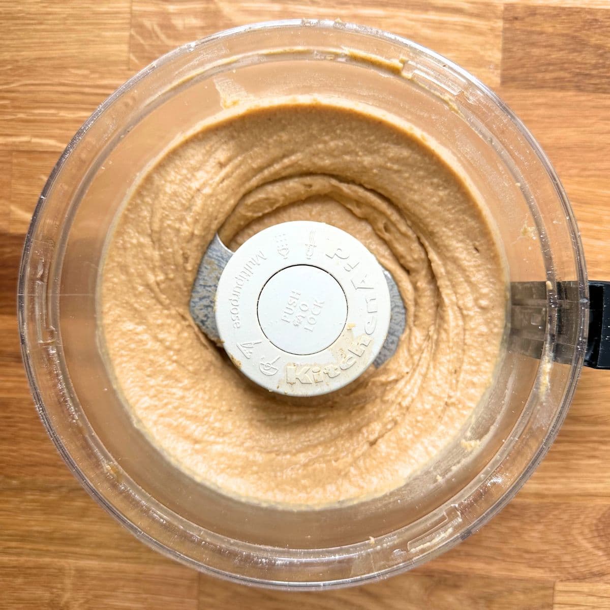 Chickpea blended with almond butter and maple syrup into a smooth batter in a food processor.