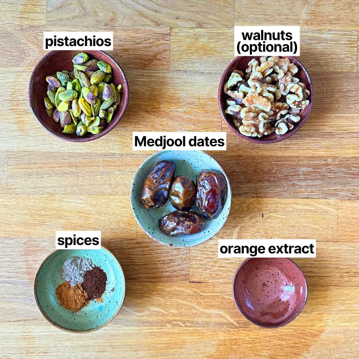 Ingredients needed to make pistachio date balls: pistachios, Medjool dates, spices, orange extract, and walnuts (optional).