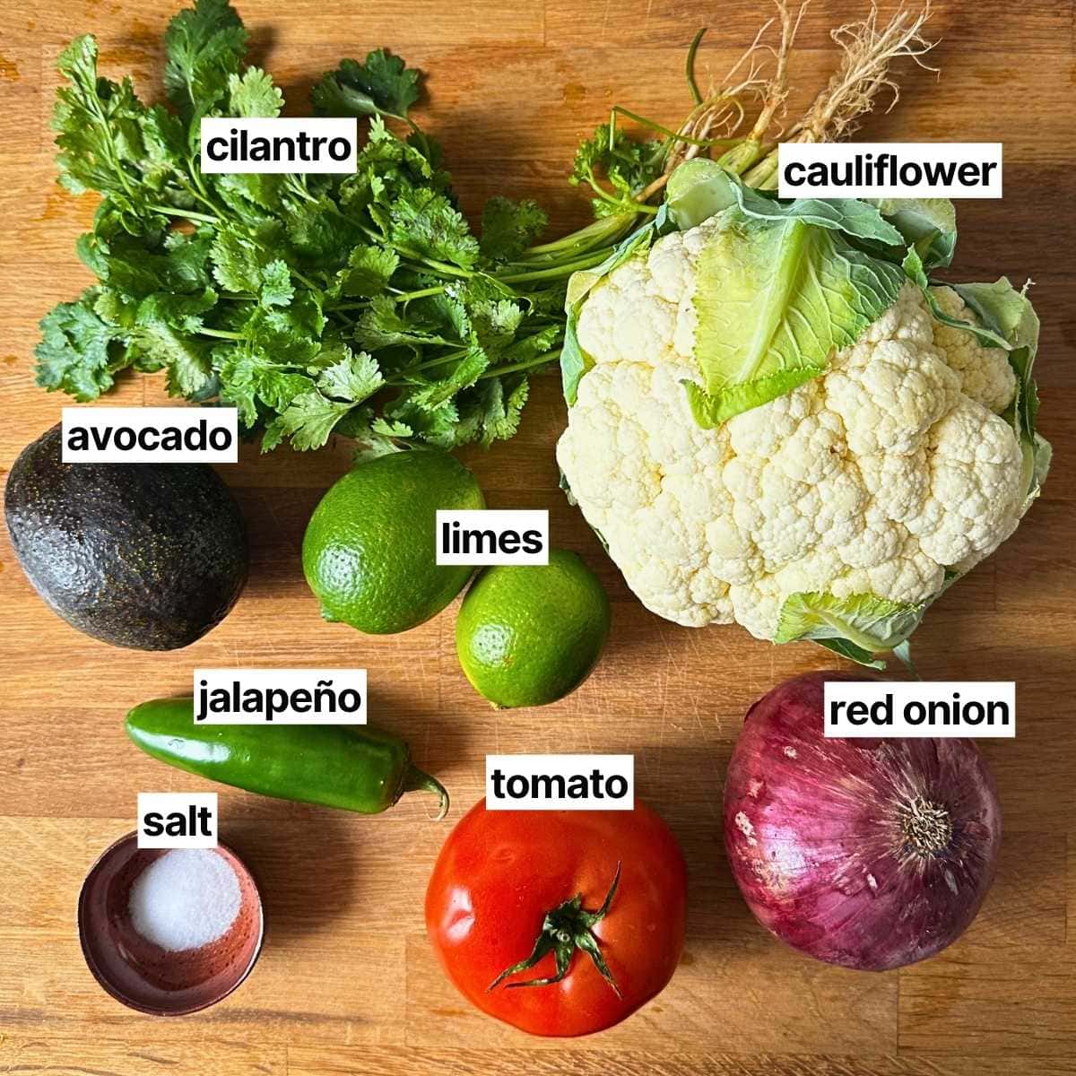 Ingredients needed to make cauliflower ceviche: cilantro, cauliflower, avocado, limes, jalapeño, tomato, red onion, and salt.