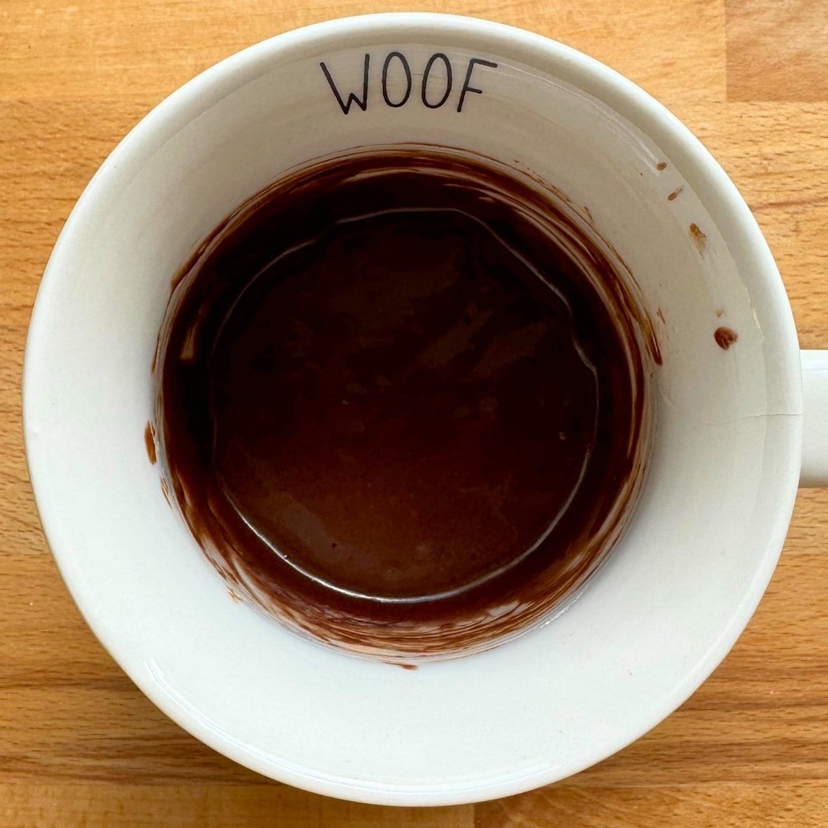 Chocolate mug cake batter mixed in a mug.