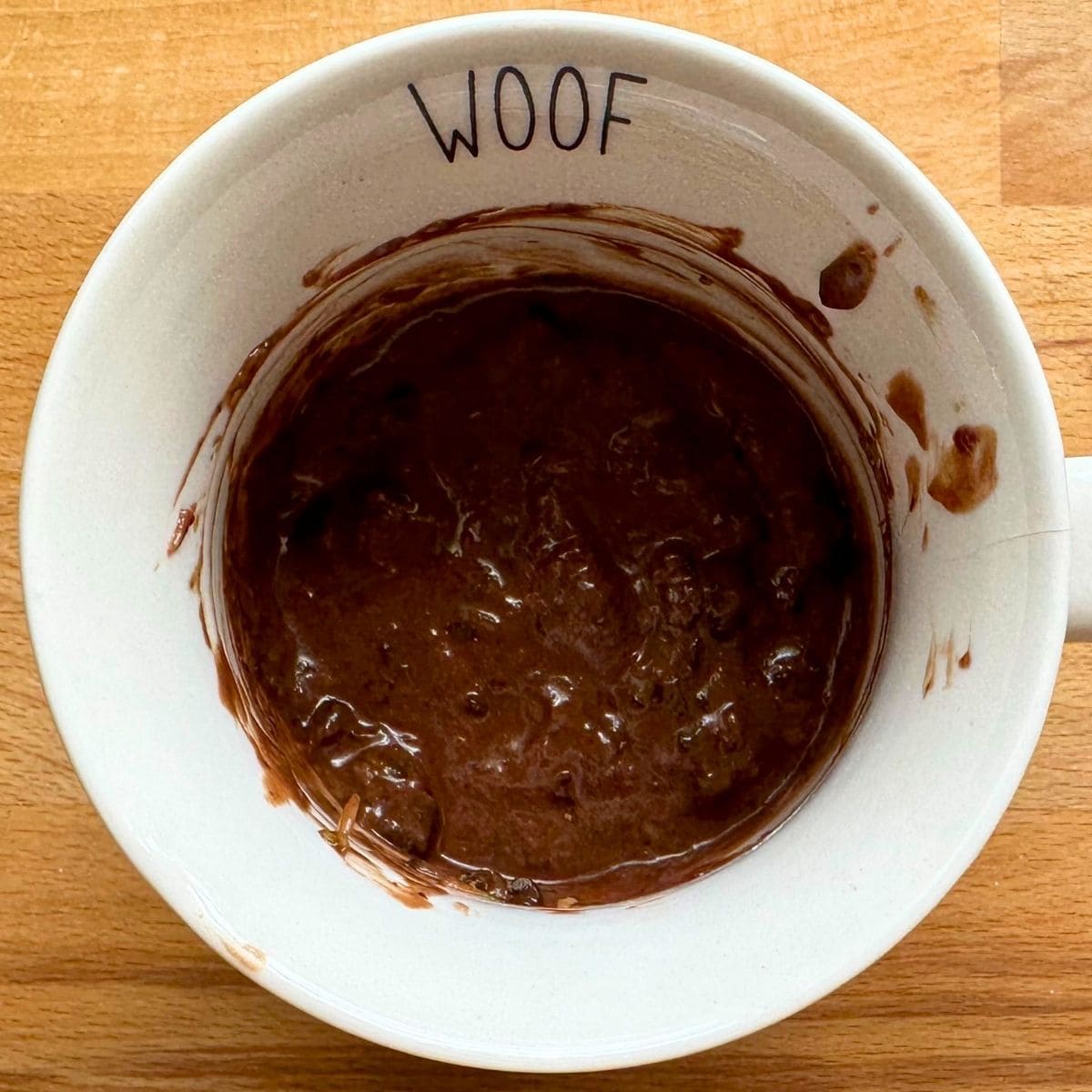 Mug cake batter mixed with zucchini shreds and chocolate chips.