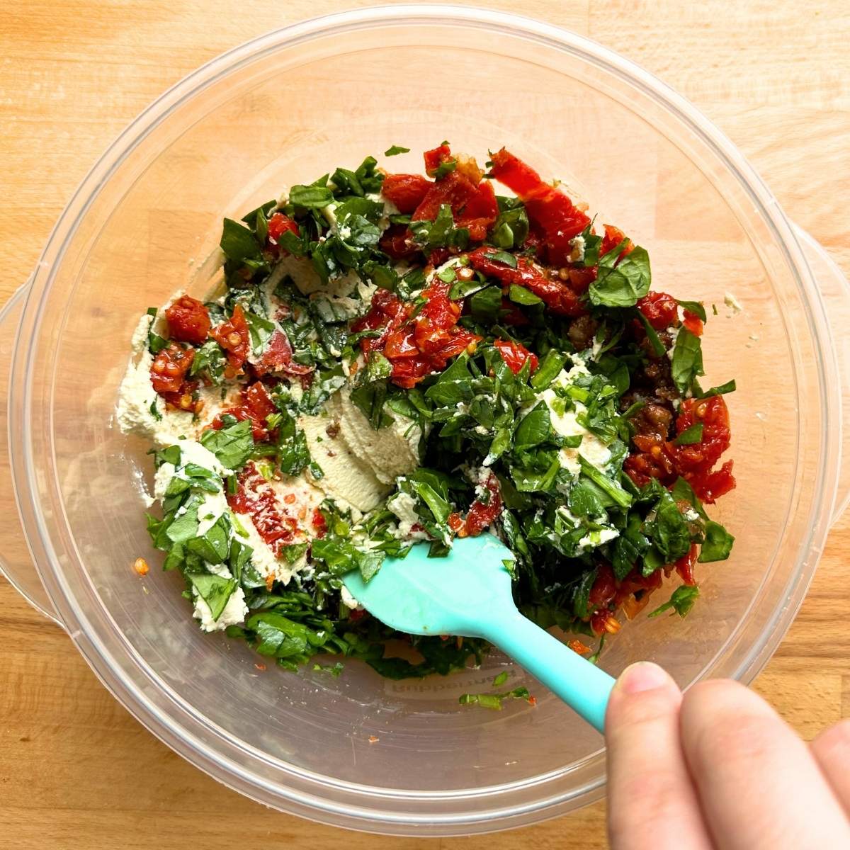 Mix tofu ricotta with spinach, garlic, and sun-dried tomato.