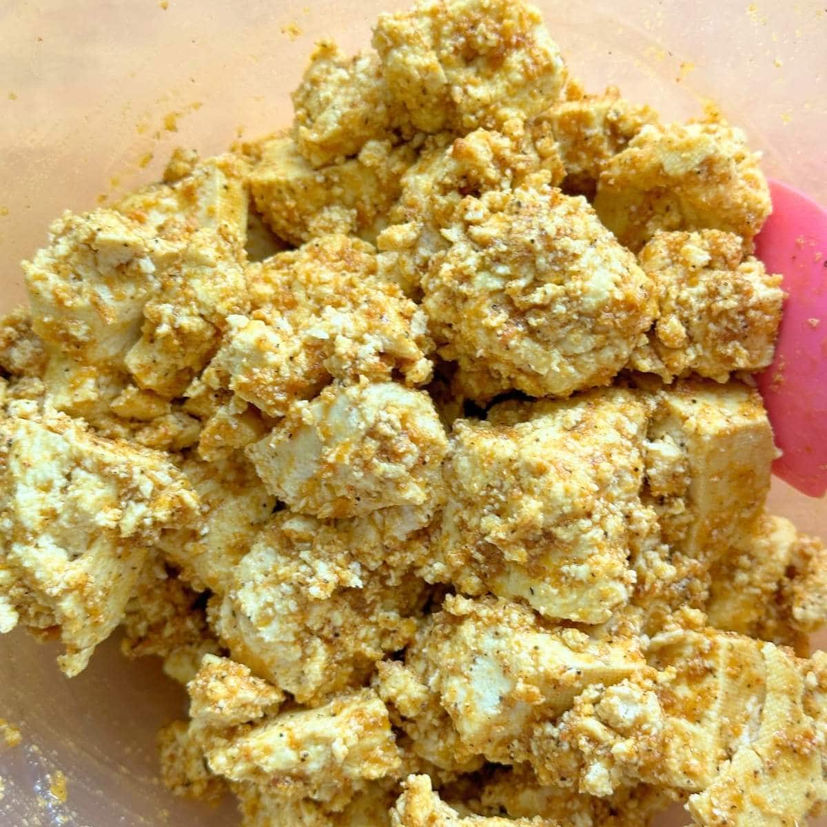 Tofu coated in the wet rub.