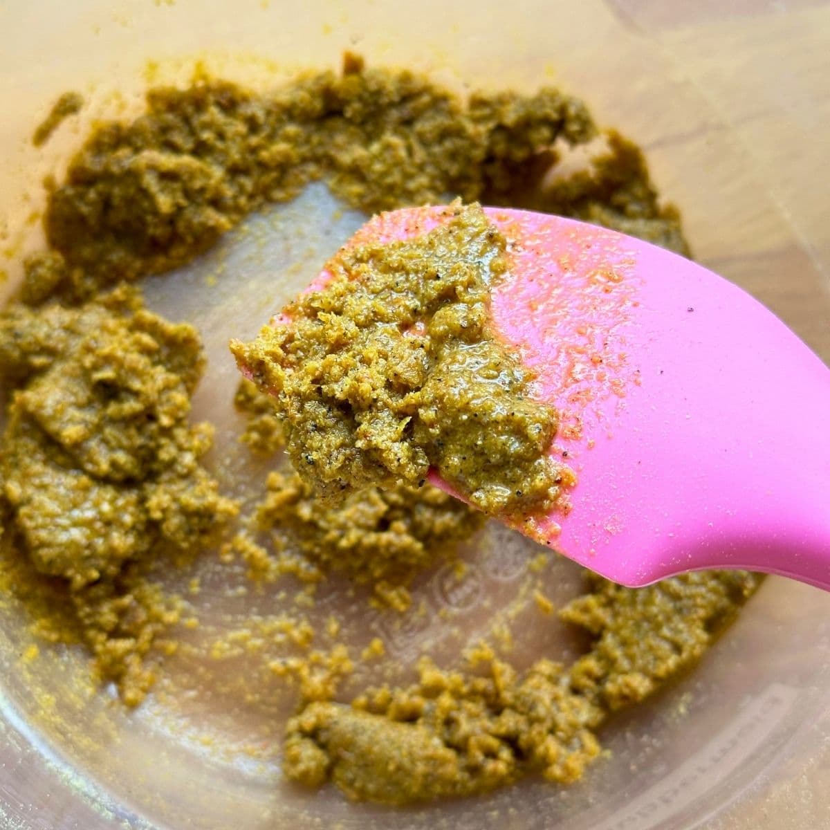 Nutritional yeast, seasoning, and olive oil mixed together to form a wet rub.