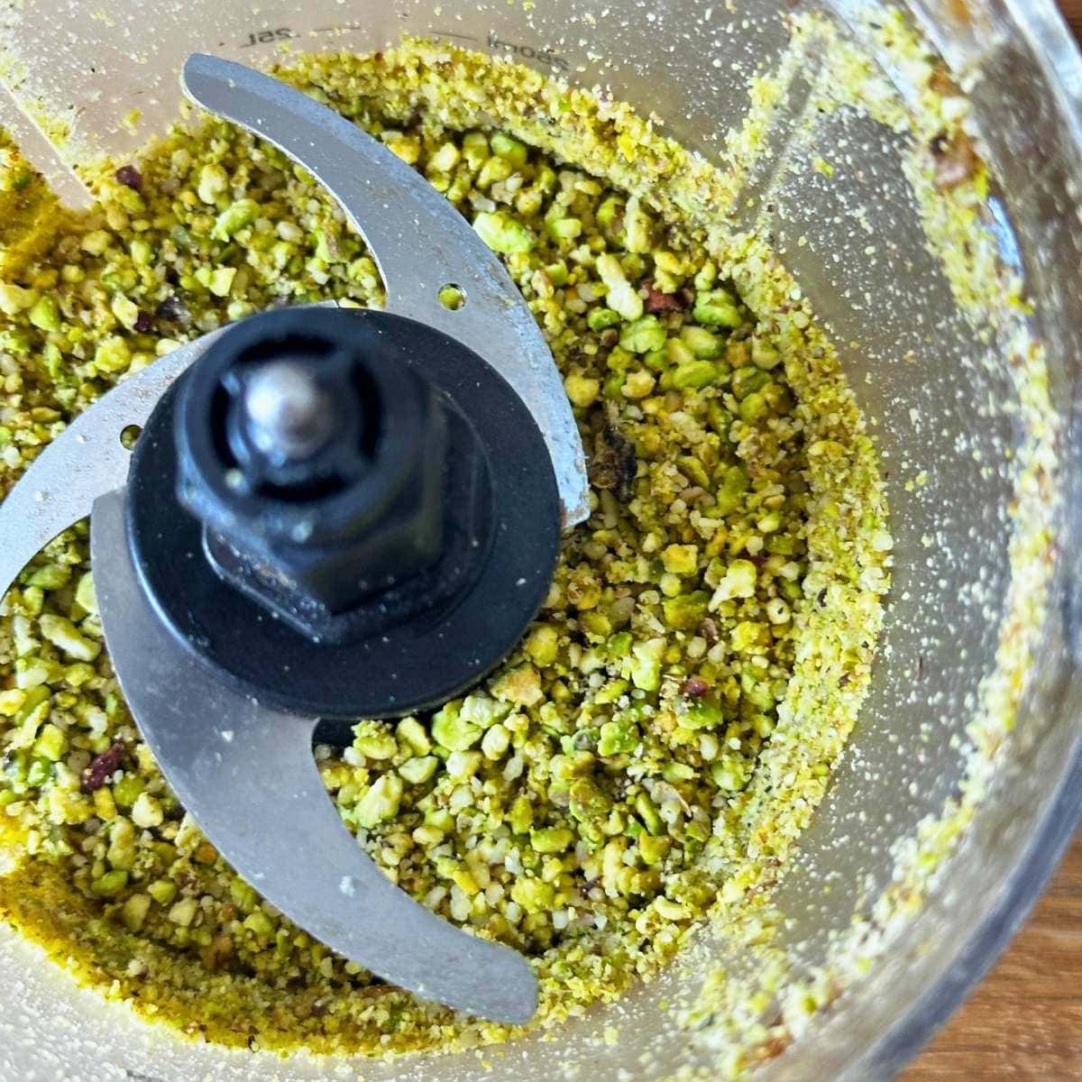 Pistachios chopped to pieces in a food processor.