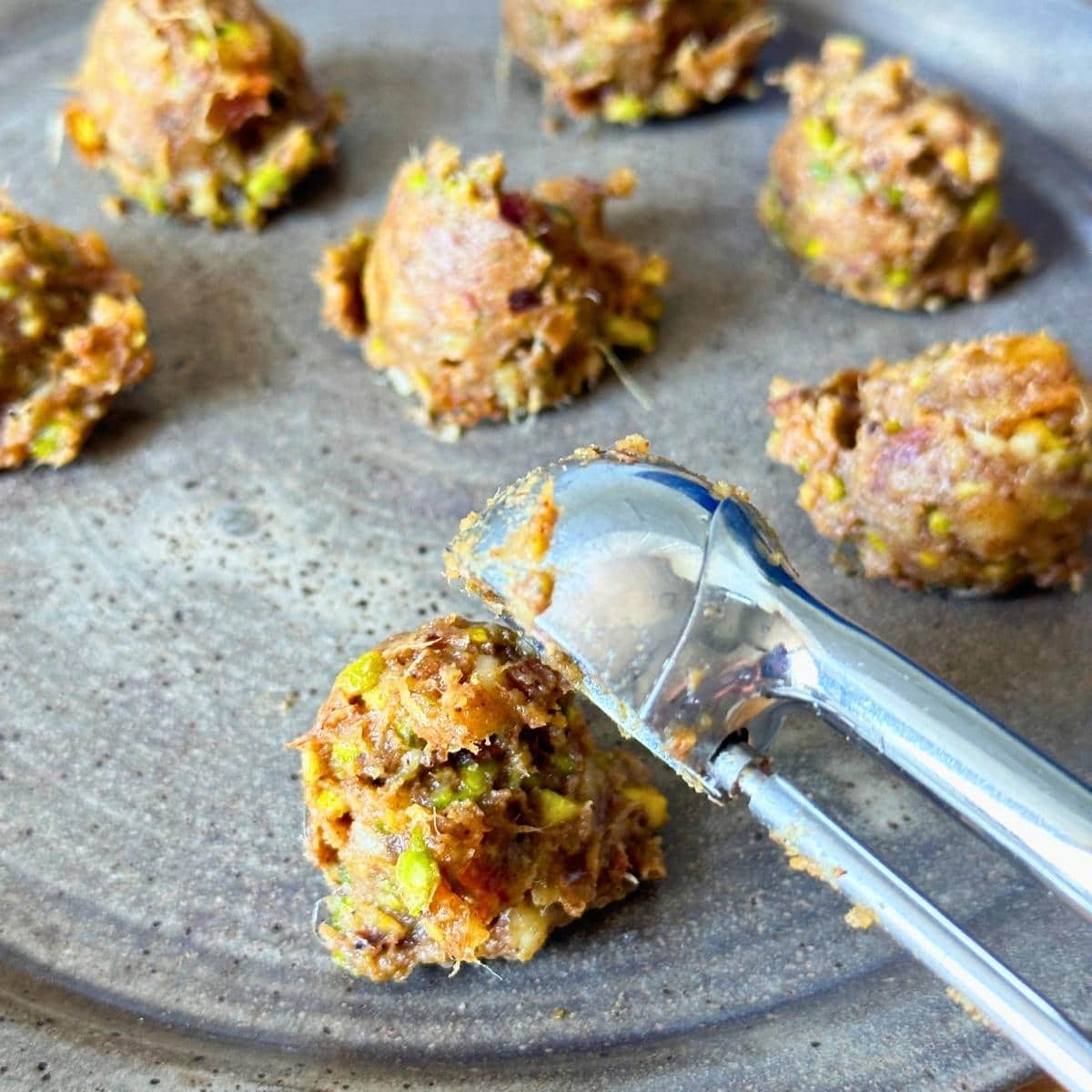 Nut and date mixture portioned with a cookie scooper.
