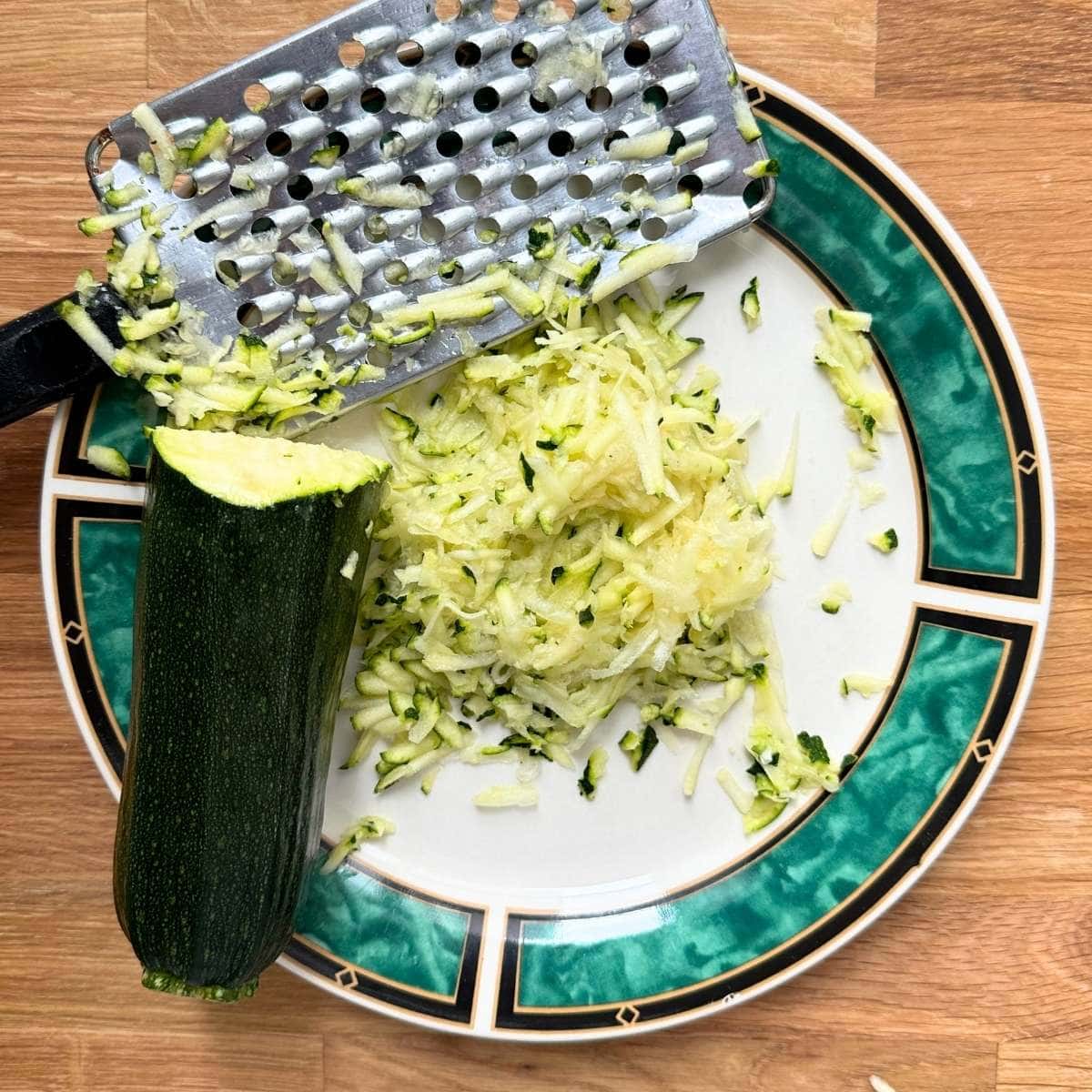 Zucchini shredded onto a plate.