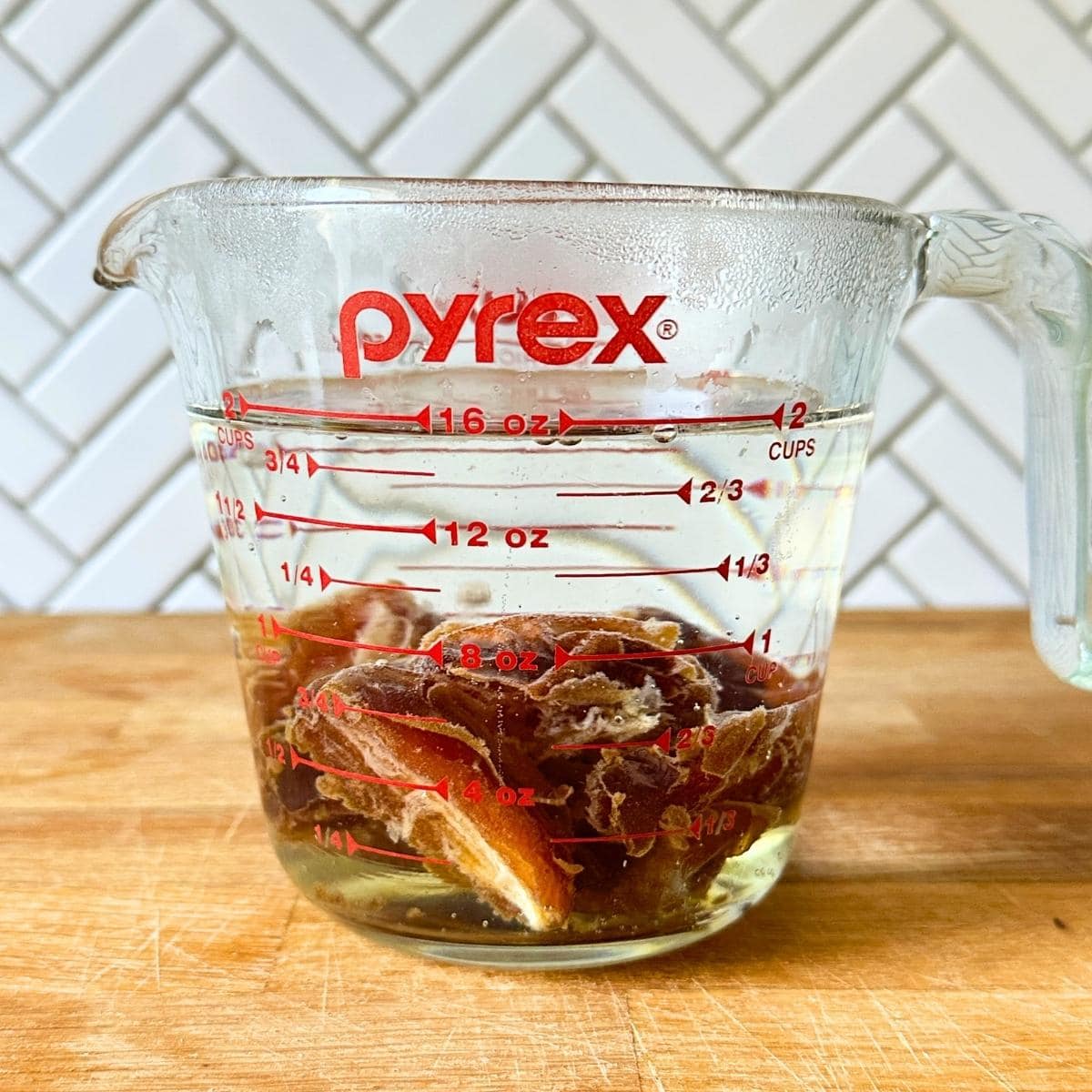 Medjool dates soaking in hot water.