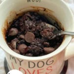 Chocolate zucchini cake in a mug with chocolate chips on top.