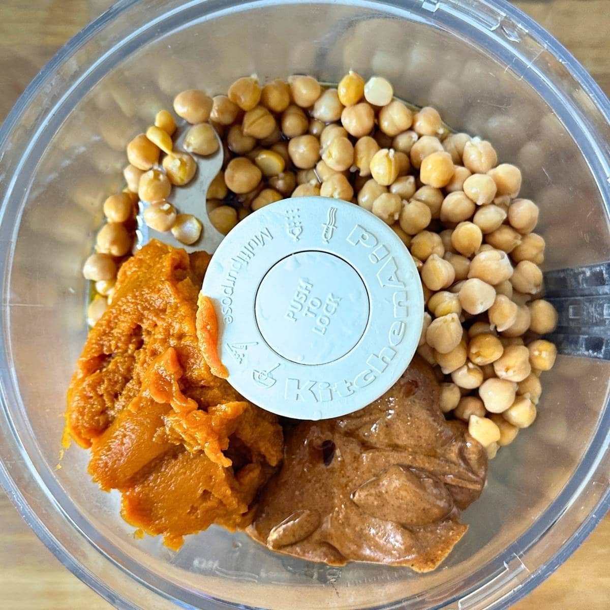 Chickpeas, pumpkin, almond butter, and maple syrup in a food processor.