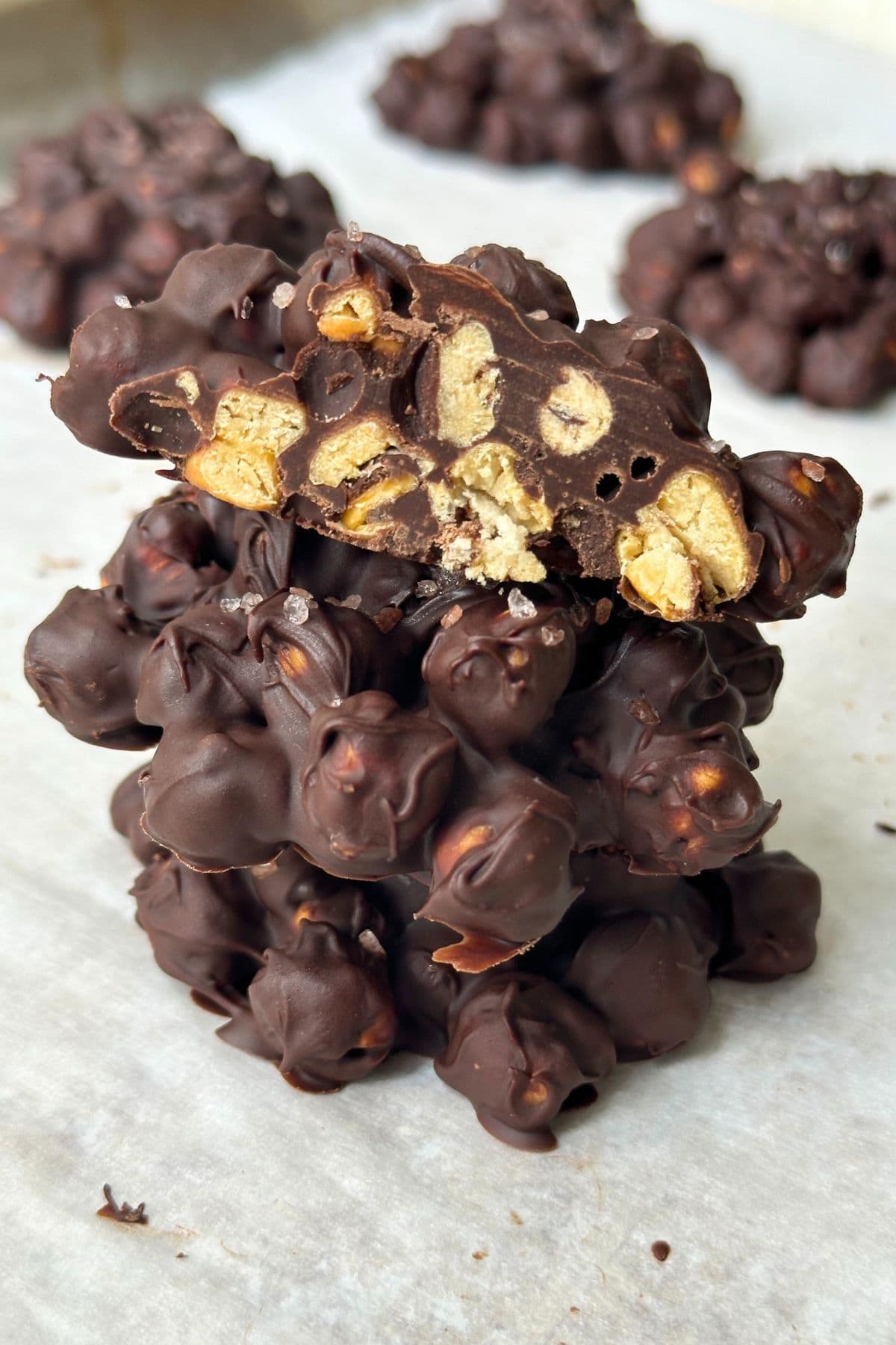 Stack of chickpea chocolate clusters with one cut in half on top.