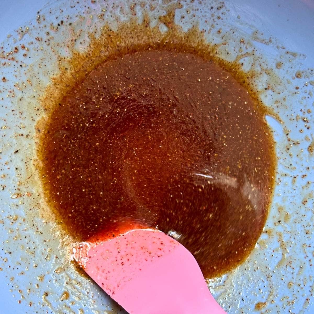 Mixing homemade barbecue sauce in a bowl,