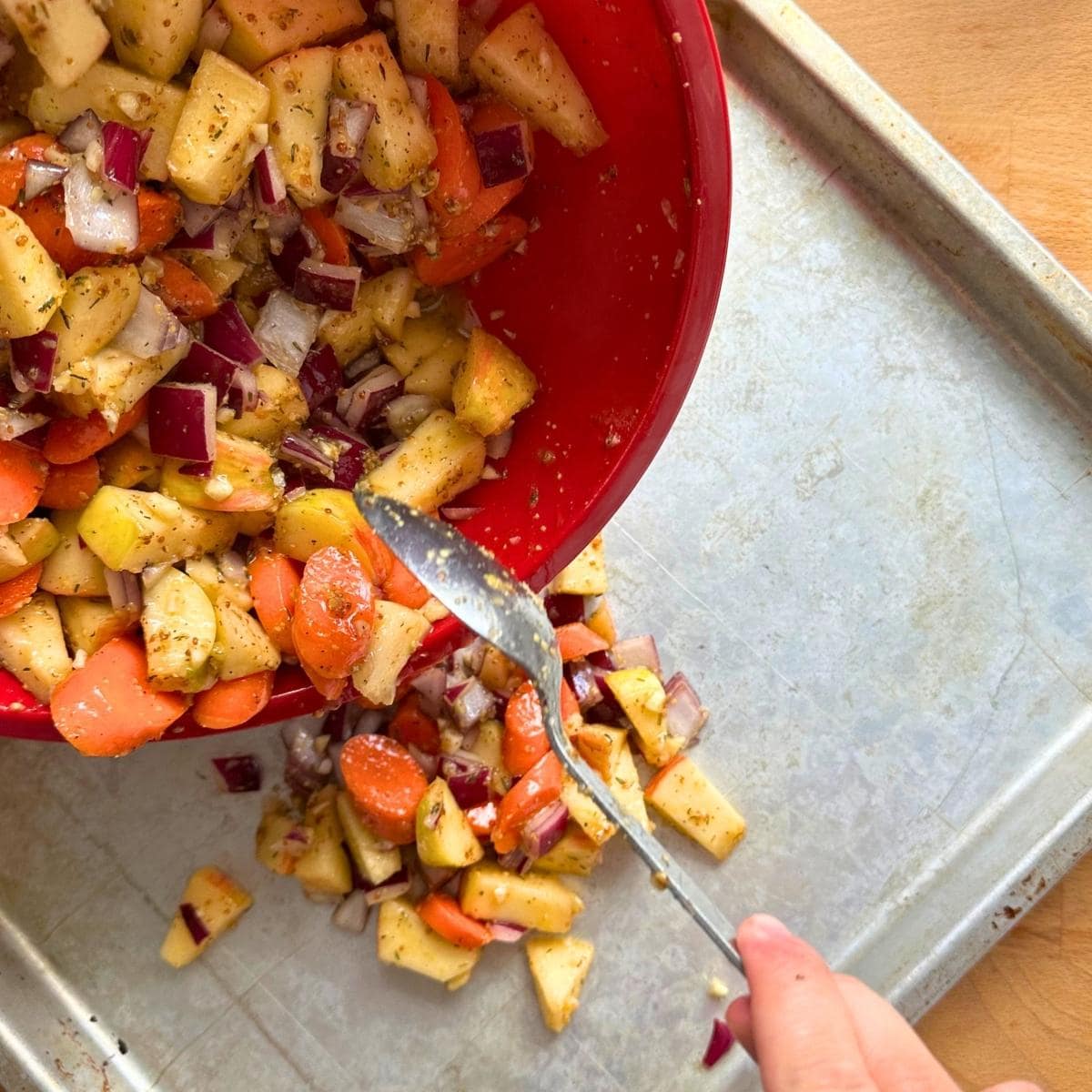 Spread apples and carrots over a clean sheet pan.