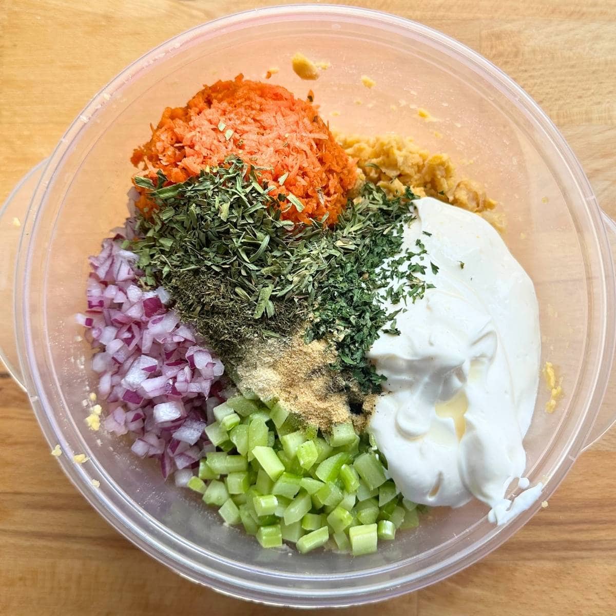All ingredients for chickpea salad piled into a bowl.