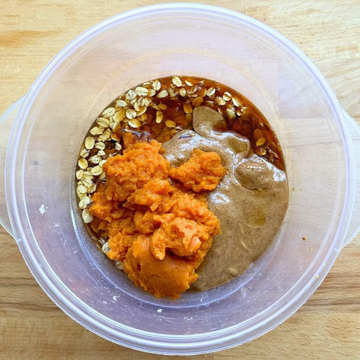 Wet ingredients added to the bowl of dry ingredients.