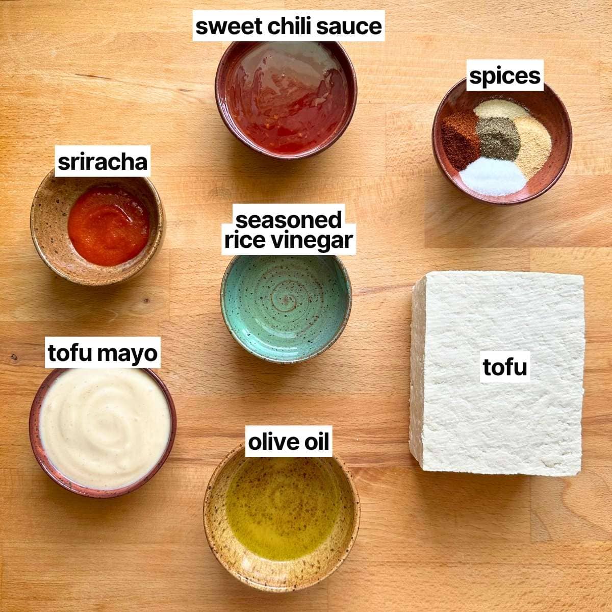 Ingredients with labels: sweet chili sauce, spices, sriracha, seasoned rice vinegar, tofu, tofu mayo, and olive oil.