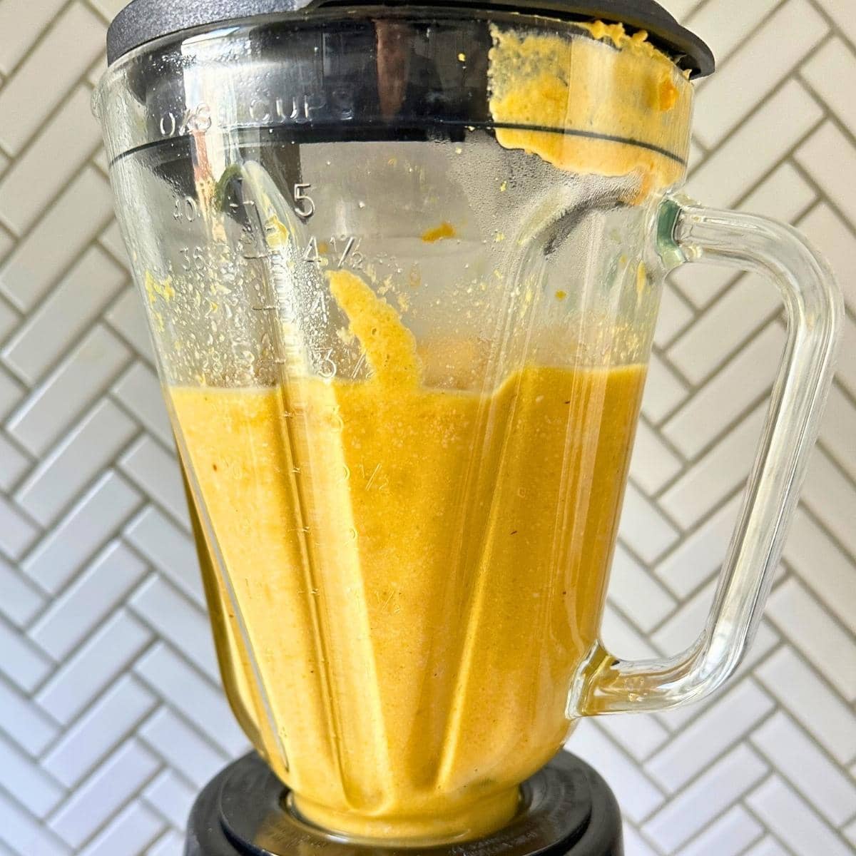 Vegan butternut cheese sauce blended up in a blender.