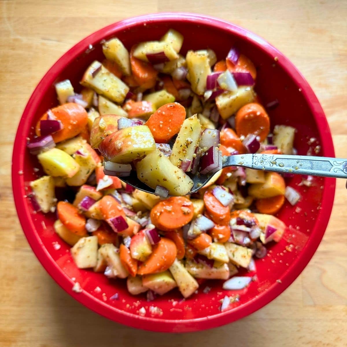 Toss carrots and apple with maple Dijon glaze in large bowl.