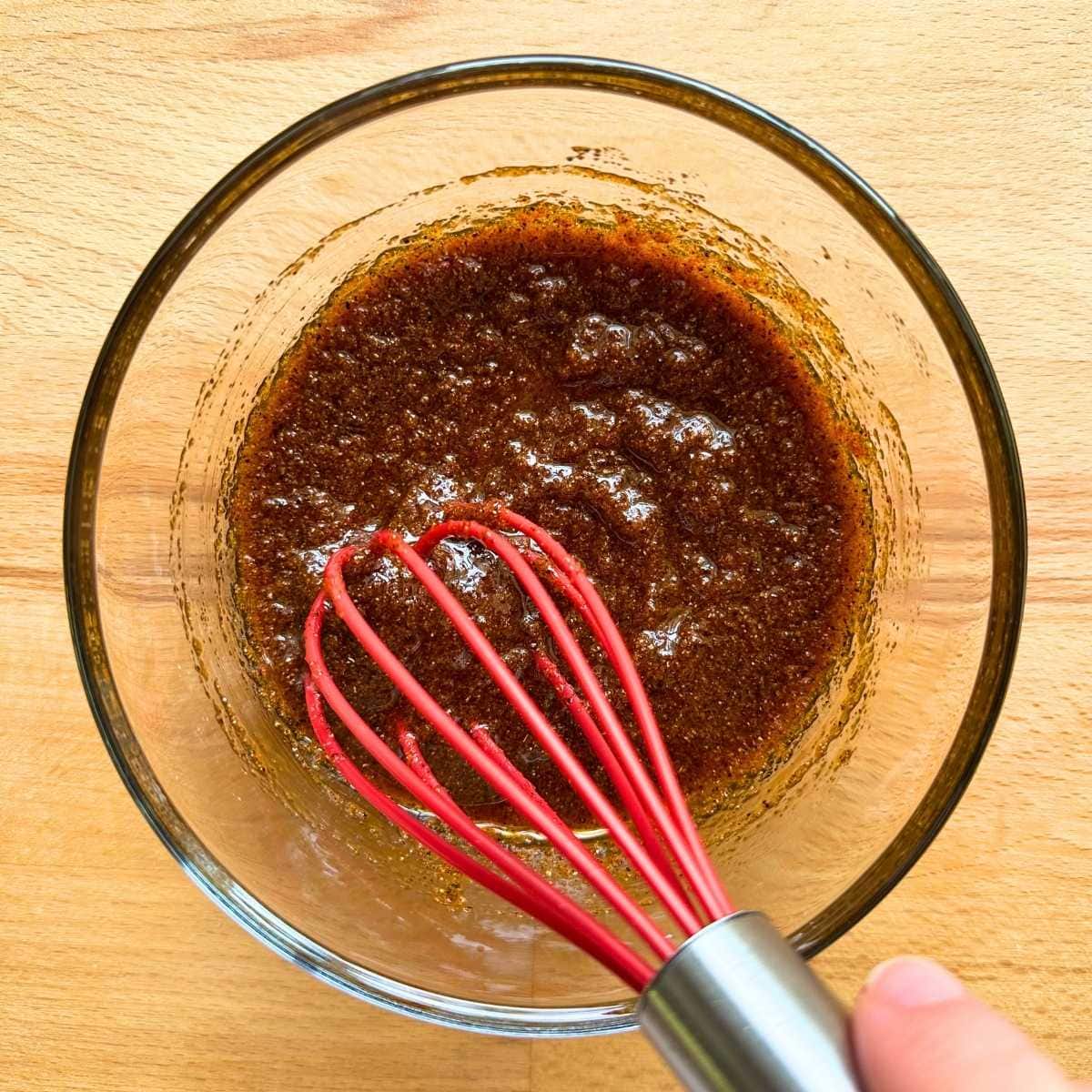Whisk together wet rub sauce with seasonings for tofu.