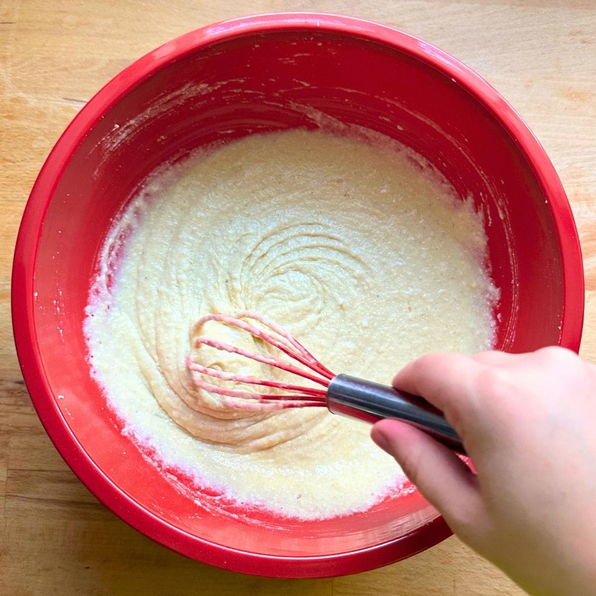 Add vegan buttermilk to dry ingredients to form cornbread batter.