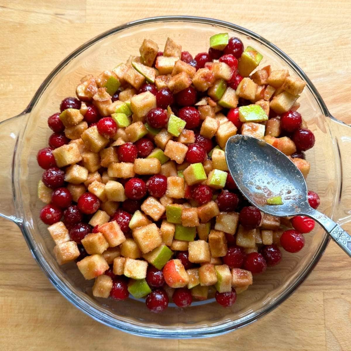 Cranberry apple crisp filling at to pie pan.