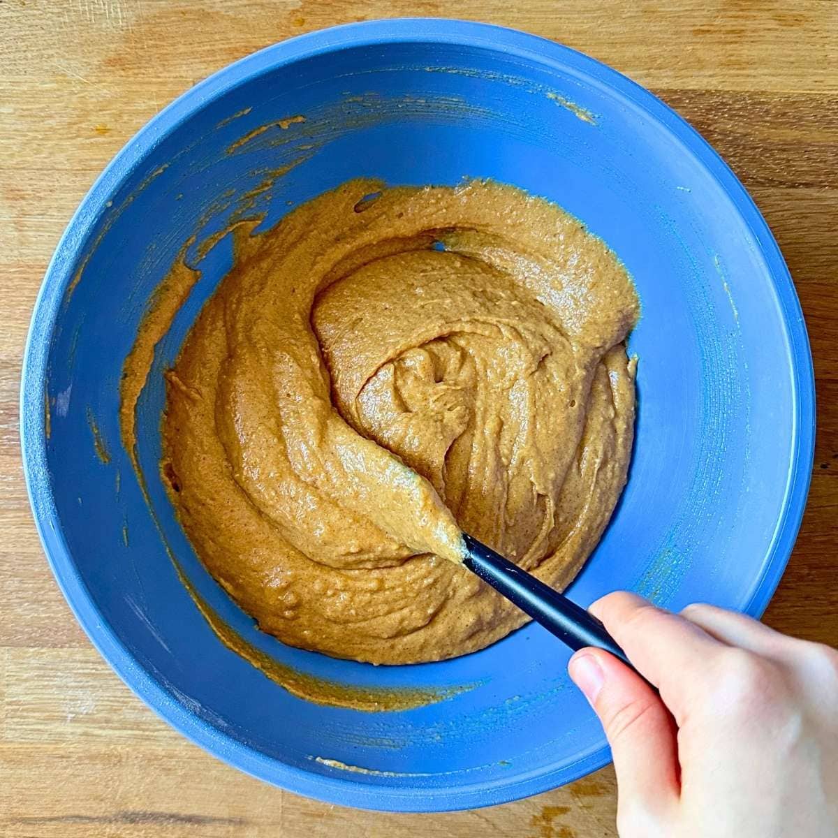 Pumpkin muffin batter, mixed together in a large bowl.
