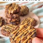 No-bake date cookie with almond butter drizzled on top, more cookies are in the background.
