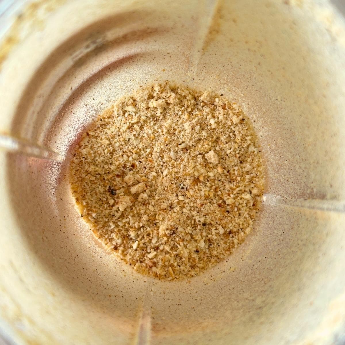 Cashews processed into fine pieces in a blender.