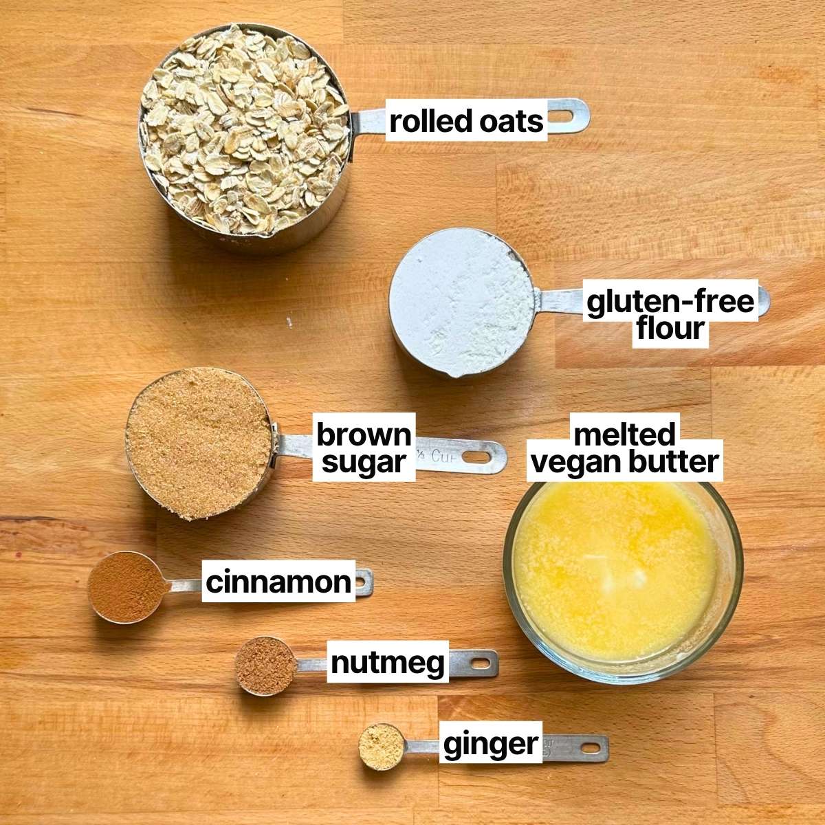 Ingredients needed to make crisp topping with labels: rolled oats, gluten-free flour, brown sugar, melted vegan butter, cinnamon, nutmeg, and ginger.